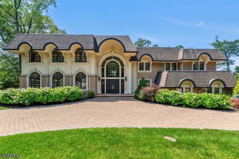 Located in one of Cresskill's most coveted neighborhoods, this exceptional manor style home offers timeless elegance resort style living.