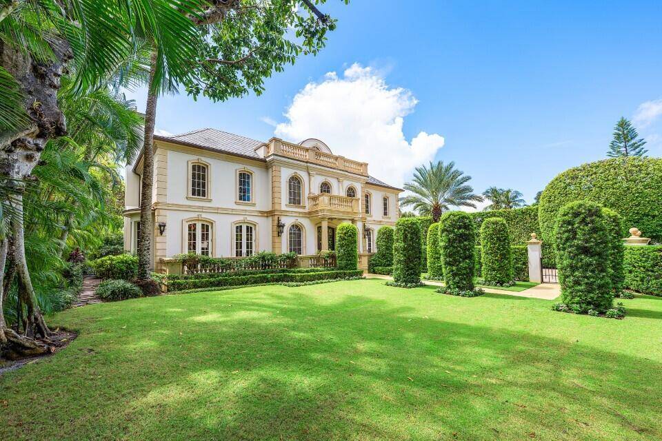 This extraordinary estate at 242 Wells Road combines classic French Provincial architecture with timeless elegance, offering an unparalleled lifestyle on one of Palm Beach's most prestigious streets.